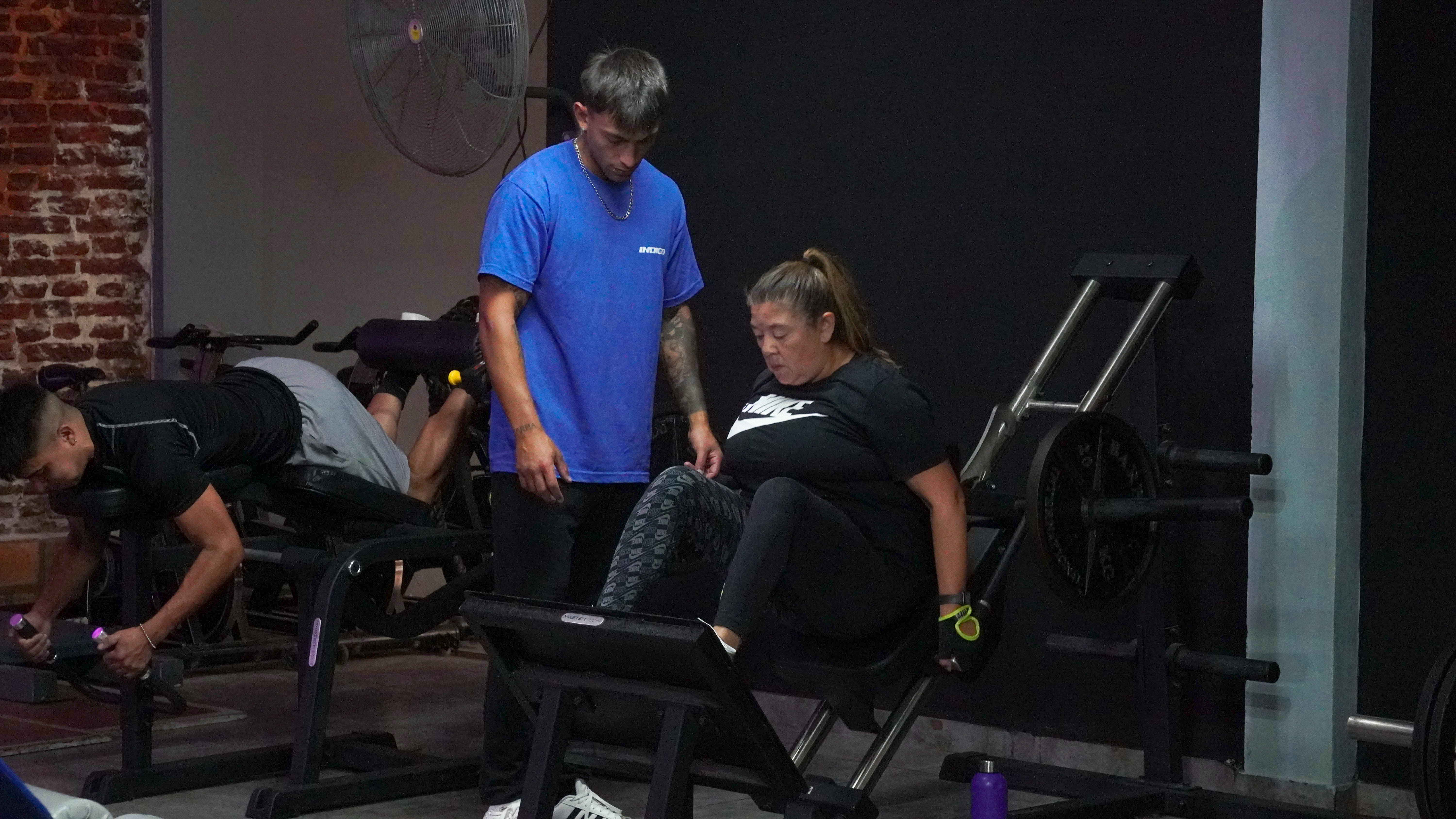 Woman stretching and doing yoga mobility exercises in dark room